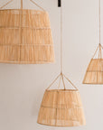 3 suspensions en raphia mises en valeur dans un salon